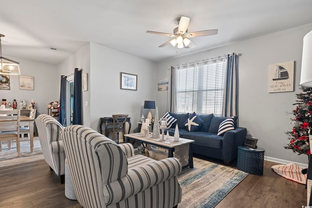 living room featuring dark hardwood / wood-style floors and ceiling fan