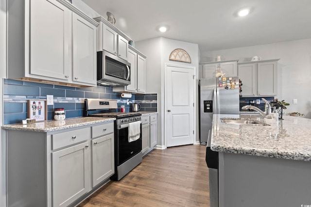 kitchen with gray cabinetry, sink, dark wood-type flooring, and appliances with stainless steel finishes