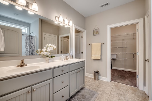 bathroom with tile patterned flooring, a shower with curtain, and vanity