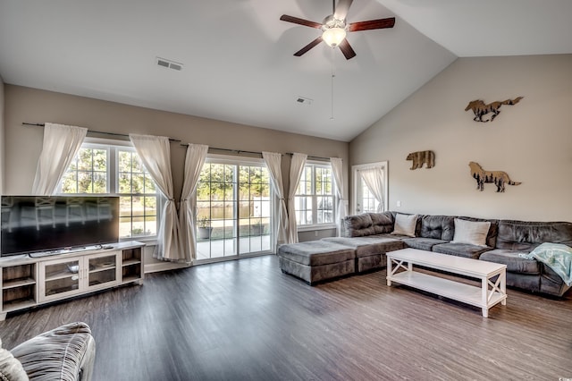 living room with hardwood / wood-style flooring, ceiling fan, and high vaulted ceiling