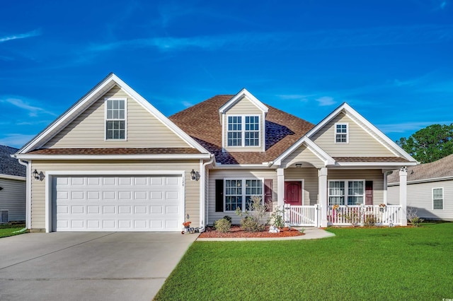 view of front of house with a garage, covered porch, and a front yard