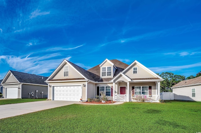 view of front of house with a front lawn, covered porch, and a garage