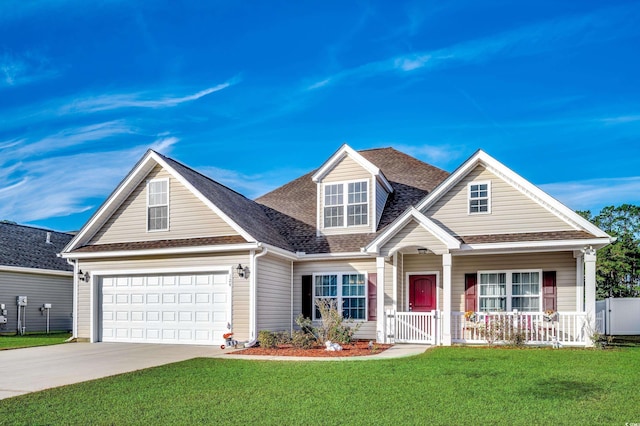 view of front of property featuring a front lawn, a porch, and a garage