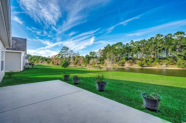 view of yard with a patio area and a water view