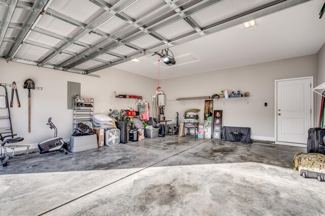 garage with electric panel and a garage door opener