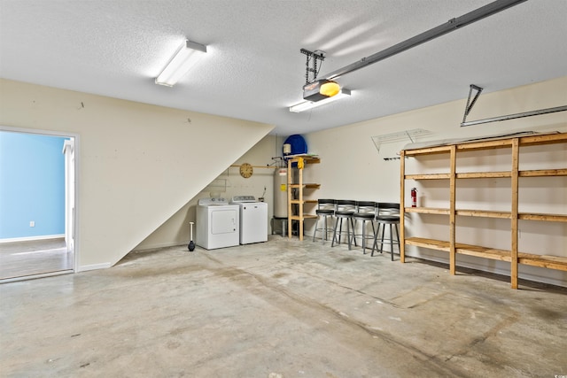 garage featuring separate washer and dryer, a garage door opener, and gas water heater