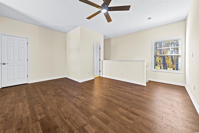 spare room with ceiling fan, dark hardwood / wood-style flooring, and a textured ceiling