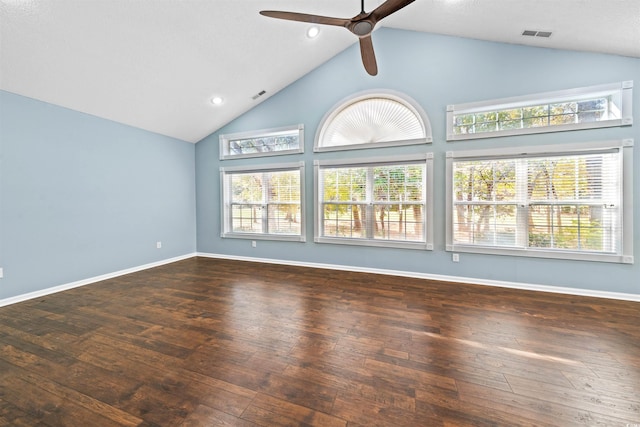 unfurnished living room with ceiling fan, high vaulted ceiling, and dark wood-type flooring