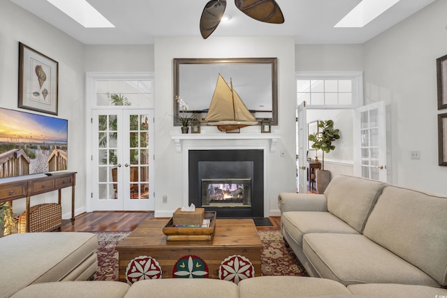 living room featuring french doors, plenty of natural light, and hardwood / wood-style floors