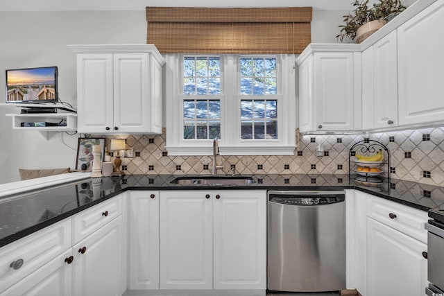 kitchen with dark stone countertops, dishwasher, white cabinets, and sink