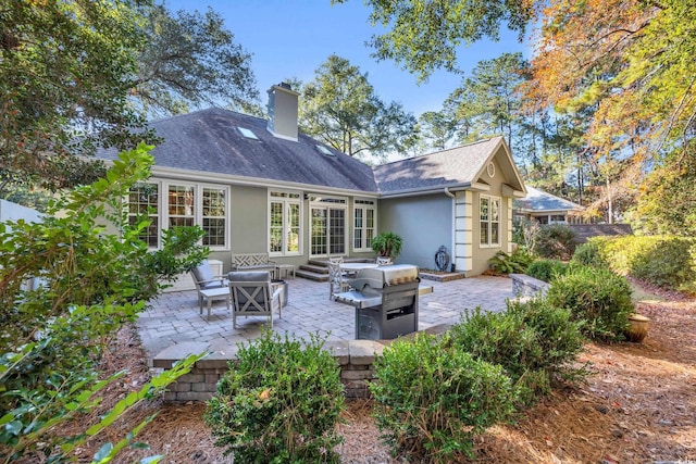 rear view of property featuring outdoor lounge area and a patio