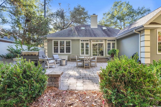 rear view of house with an outdoor hangout area and a patio area