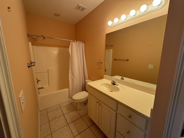 full bathroom featuring tile patterned floors, a textured ceiling, toilet, vanity, and shower / tub combo