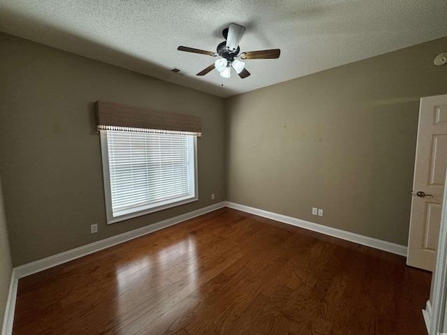 unfurnished room with a textured ceiling, ceiling fan, and dark hardwood / wood-style floors