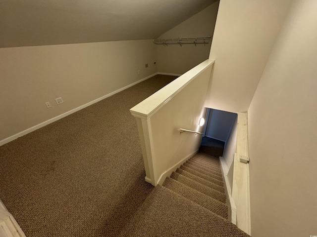 staircase with carpet and lofted ceiling