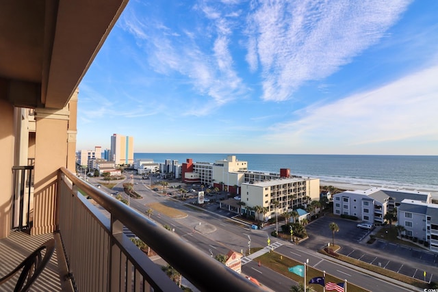 balcony featuring a view of the beach and a water view