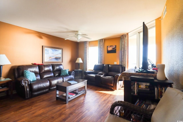 living room featuring dark hardwood / wood-style flooring and ceiling fan