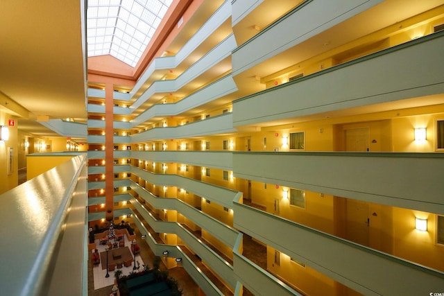 hallway featuring a towering ceiling