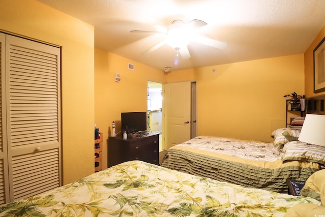 bedroom featuring ceiling fan, a closet, and a textured ceiling