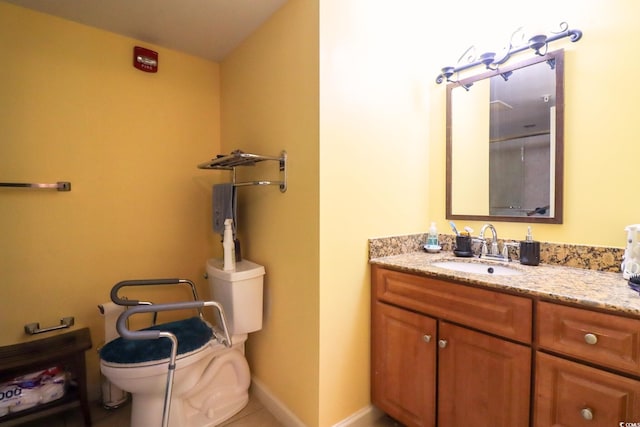 bathroom featuring tile patterned flooring, vanity, and toilet