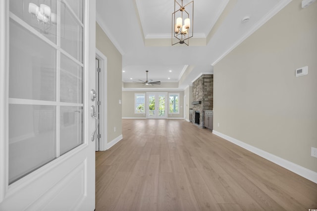2515 Saint Andrews Dr, Little River, SC 29566 - unfurnished living room with a raised ceiling, a chandelier, light wood-type flooring, a fireplace, and crown molding