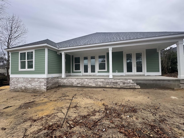 rear view of house featuring french doors