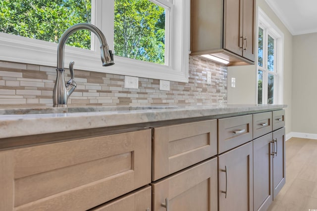 2515 Saint Andrews Dr, Little River, SC 29566 - kitchen with a sink, backsplash, baseboards, crown molding, and plenty of natural light