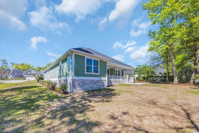 2515 Saint Andrews Dr, Little River, SC 29566 - view of home's exterior featuring a porch and a lawn