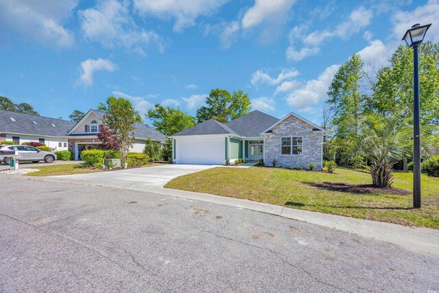 2515 Saint Andrews Dr, Little River, SC 29566 - view of front facade with driveway, stone siding, a front yard, and an attached garage