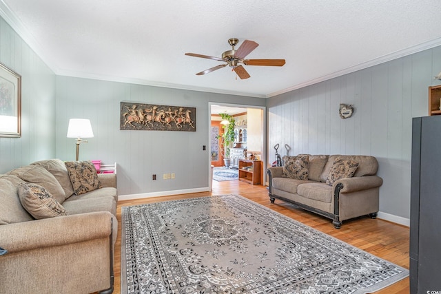 1692 S Morgan Ave, Andrews, SC 29510 - living area featuring light wood-type flooring, crown molding, a ceiling fan, wooden walls, and baseboards
