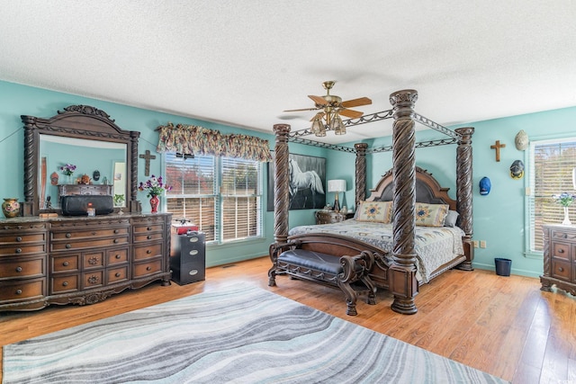 1692 S Morgan Ave, Andrews, SC 29510 - bedroom with a textured ceiling, wood finished floors, a ceiling fan, and baseboards