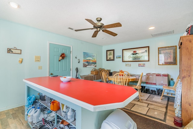 1692 S Morgan Ave, Andrews, SC 29510 - kitchen featuring light wood finished floors, a ceiling fan, a textured ceiling, recessed lighting, and a decorative wall