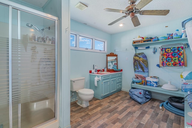 1692 S Morgan Ave, Andrews, SC 29510 - full bathroom with a stall shower, wood finished floors, ceiling fan, toilet, and a textured ceiling