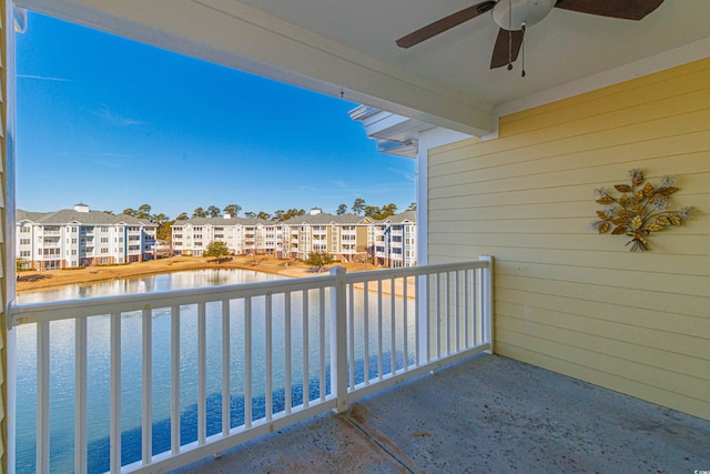 balcony with ceiling fan and a water view