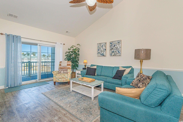 living room with wood-type flooring, high vaulted ceiling, and ceiling fan