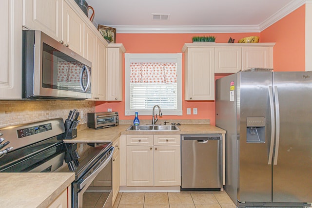 kitchen featuring sink, stainless steel appliances, ornamental molding, light tile patterned flooring, and decorative backsplash