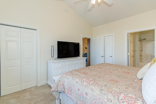 bedroom with ensuite bath, ceiling fan, high vaulted ceiling, light colored carpet, and multiple closets