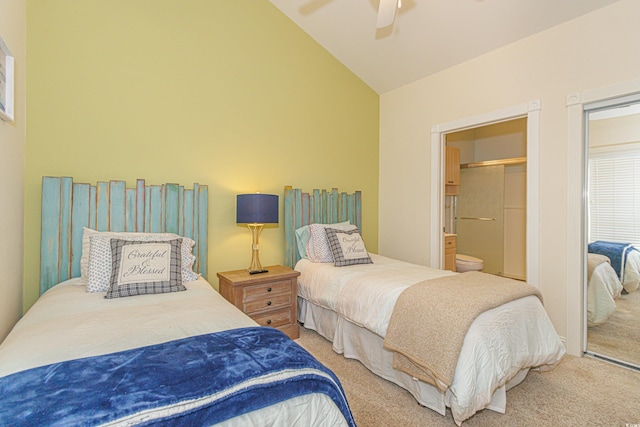 bedroom featuring ensuite bathroom, lofted ceiling, carpet flooring, and ceiling fan