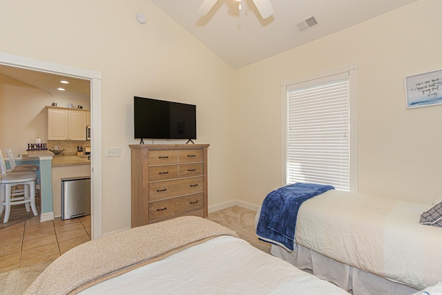 bedroom with lofted ceiling, light tile patterned floors, and ceiling fan