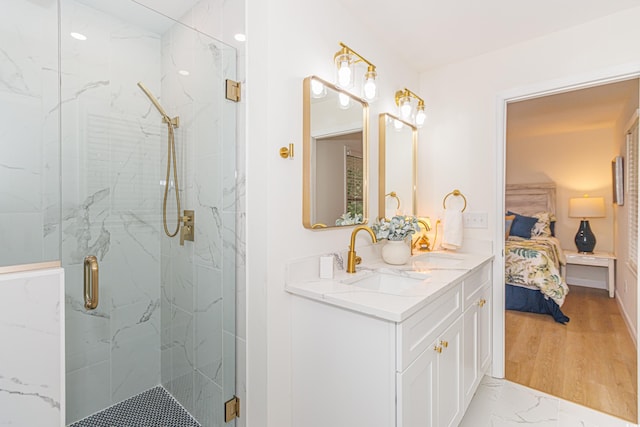 bathroom with hardwood / wood-style flooring, vanity, and walk in shower