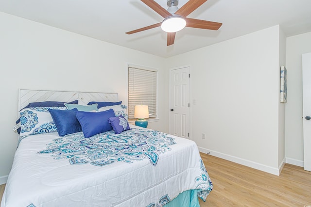 bedroom featuring hardwood / wood-style flooring and ceiling fan