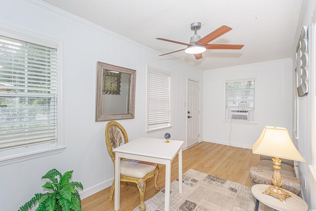 office area with plenty of natural light, cooling unit, light hardwood / wood-style floors, and ornamental molding