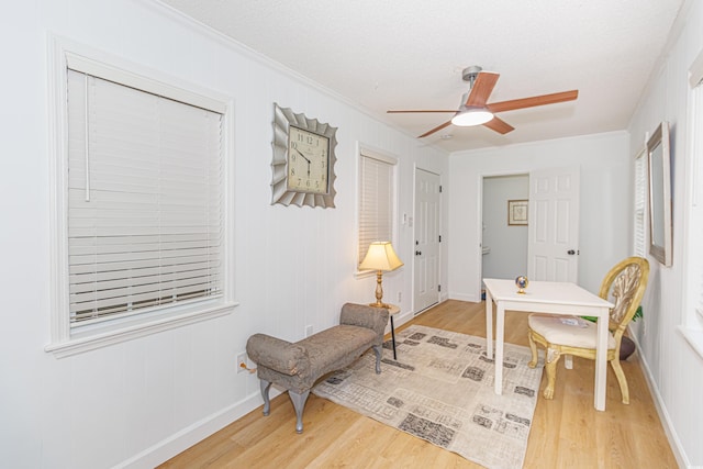 sitting room featuring crown molding, ceiling fan, and wood-type flooring