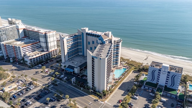 drone / aerial view with a water view and a beach view