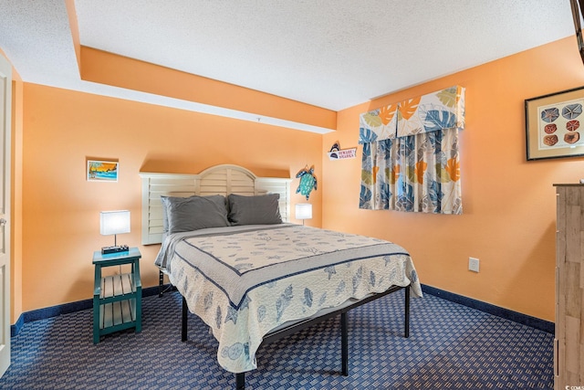 bedroom with carpet flooring and a textured ceiling