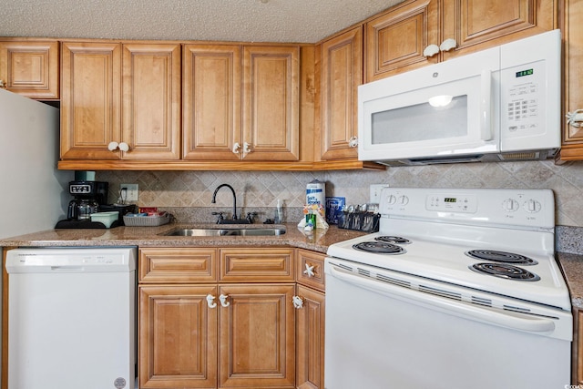 kitchen with a textured ceiling, decorative backsplash, sink, and white appliances