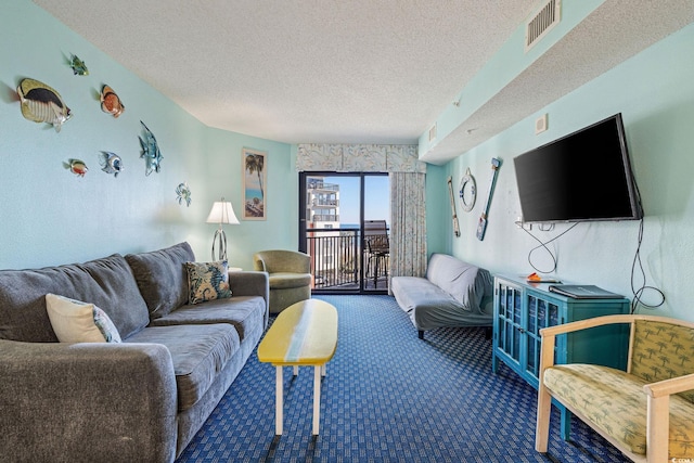 carpeted living room with a textured ceiling