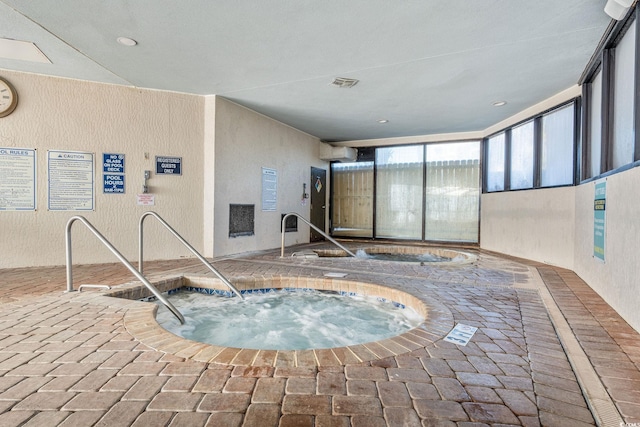 view of swimming pool featuring an indoor in ground hot tub