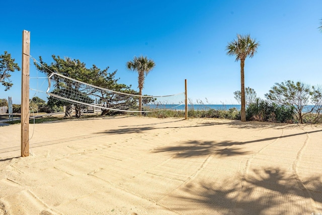 surrounding community featuring a water view and volleyball court