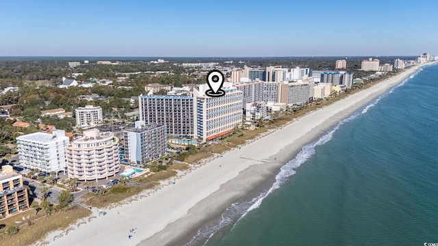 birds eye view of property with a view of the beach and a water view